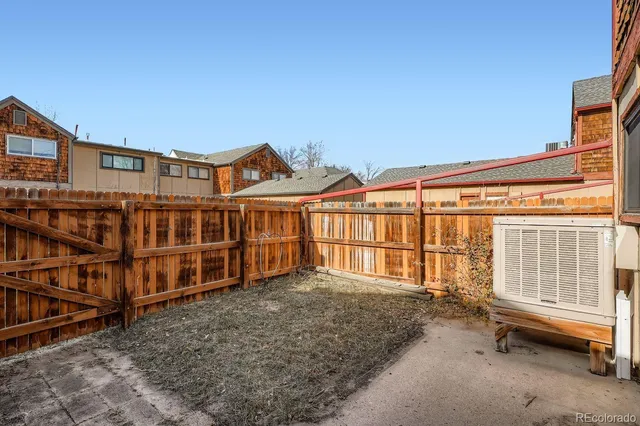 a view of a blue house with large windows
