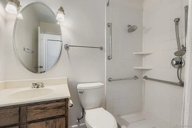 a bathroom with a sink toilet and shower