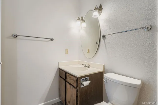 a bathroom with a sink toilet and a mirror
