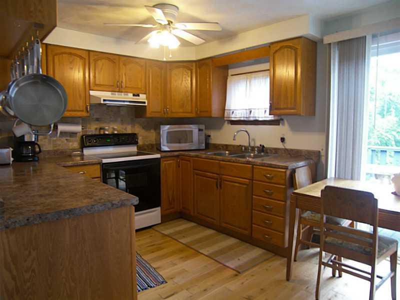 106 Santa Barbara Road Smithton, PA 15479 - Photo 4 of 19 Kitchen. Kitchen with hardwood floors and doors leading out to back deck
