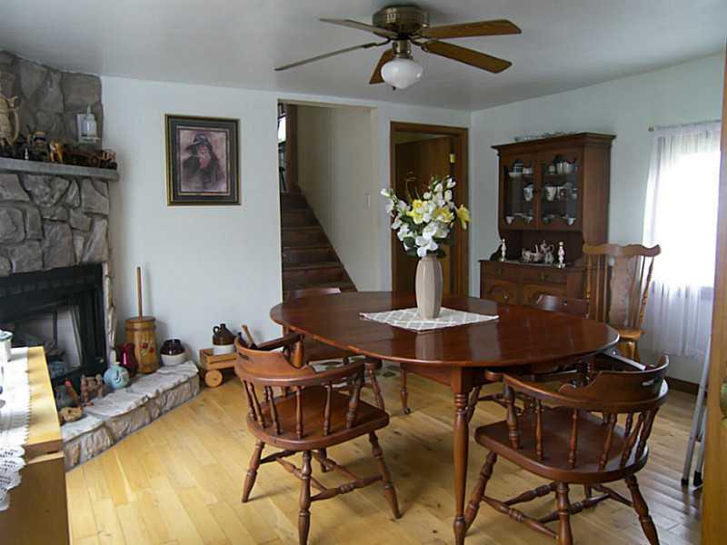 106 Santa Barbara Road Smithton, PA 15479 - Photo 6 of 19 Dining Room. Formal dining room with Beautiful stone fireplace, hardwood floors and glass doors leading out to back deck