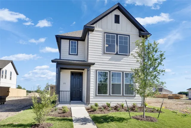 a front view of a house with a yard