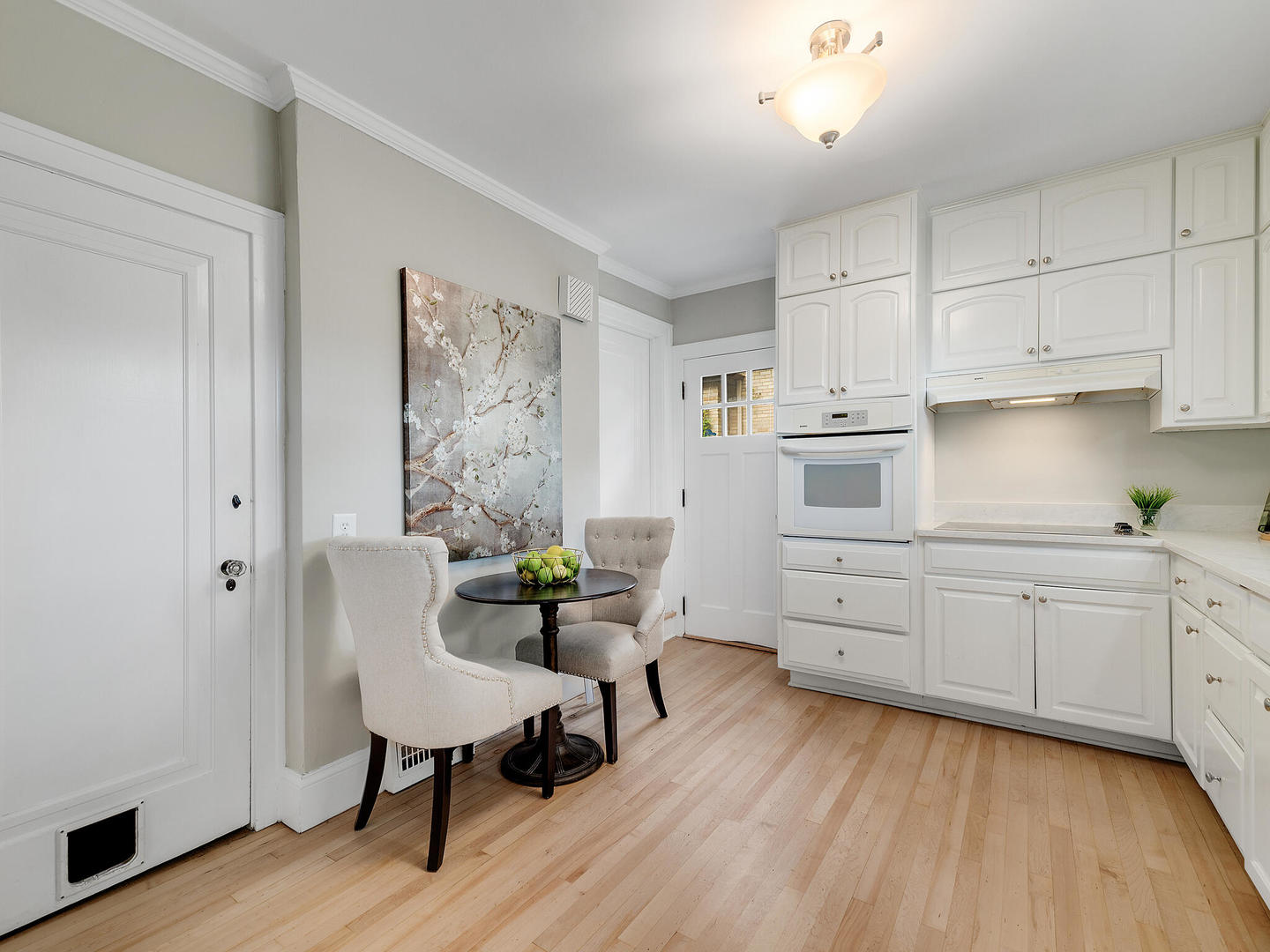 161 E Road Glen Ellyn, IL 60137 - Photo 15 of 27 a kitchen with cabinets and wooden floor