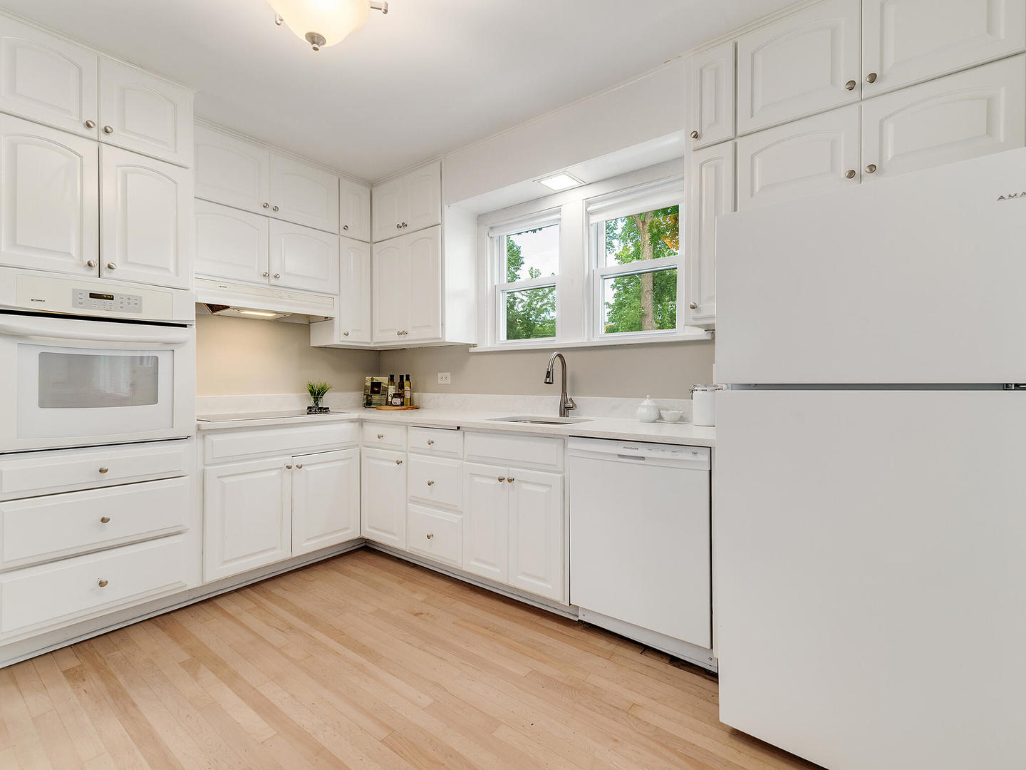 161 E Road Glen Ellyn, IL 60137 - Photo 17 of 27 a kitchen with white cabinets and white appliances