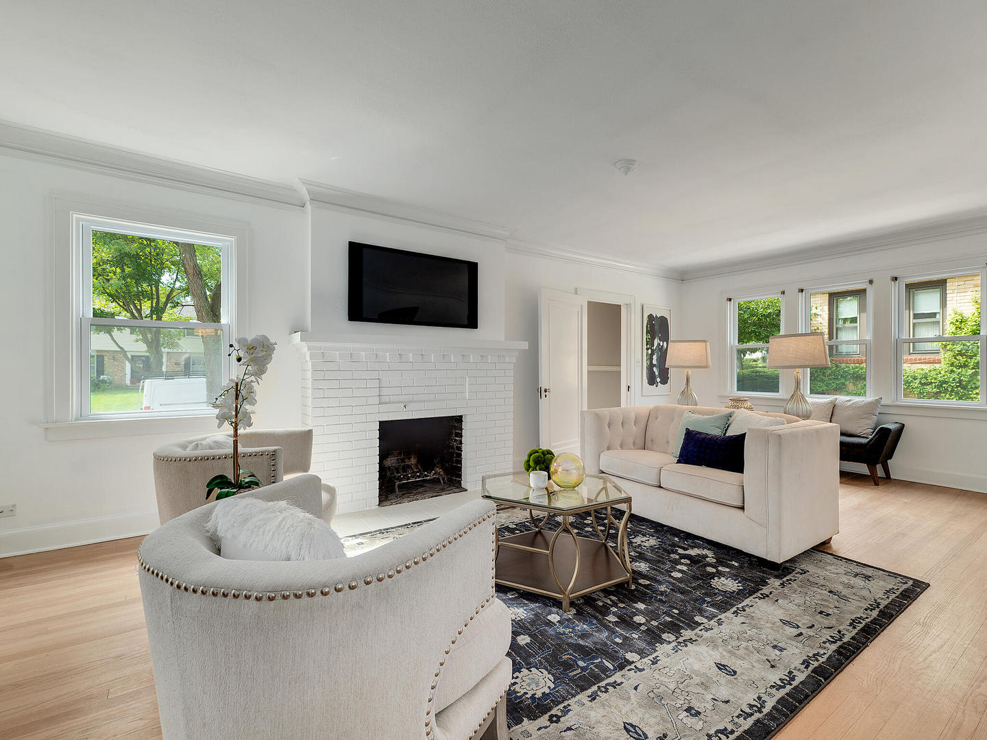 161 E Road Glen Ellyn, IL 60137 - Photo 7 of 27 a living room with furniture a fireplace and a flat screen tv