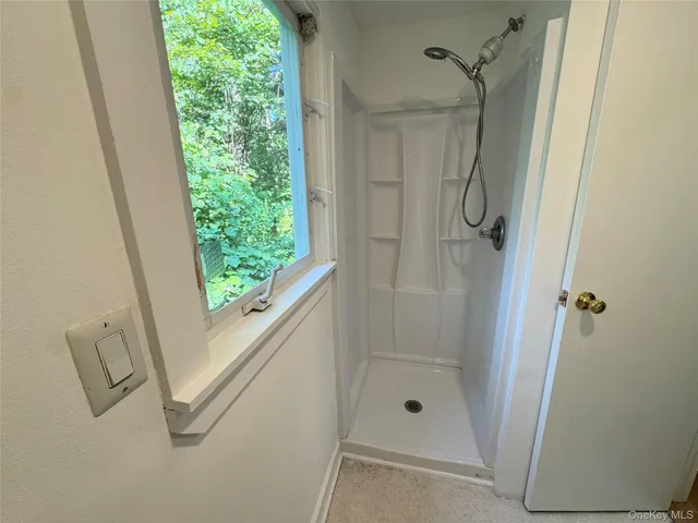 a bathroom with a glass shower door