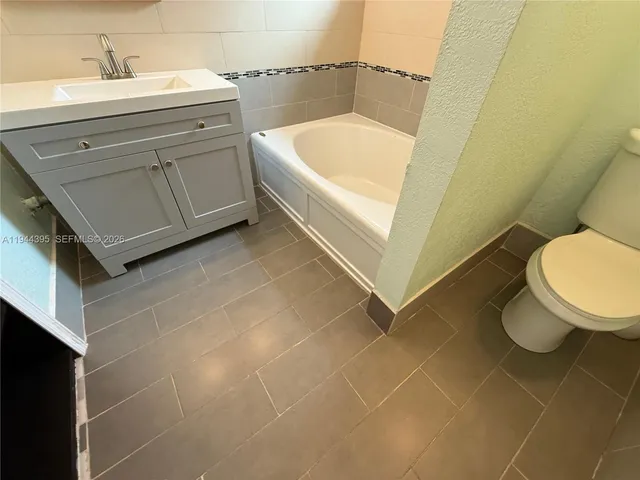 a bathroom with a sink a toilet and bathtub