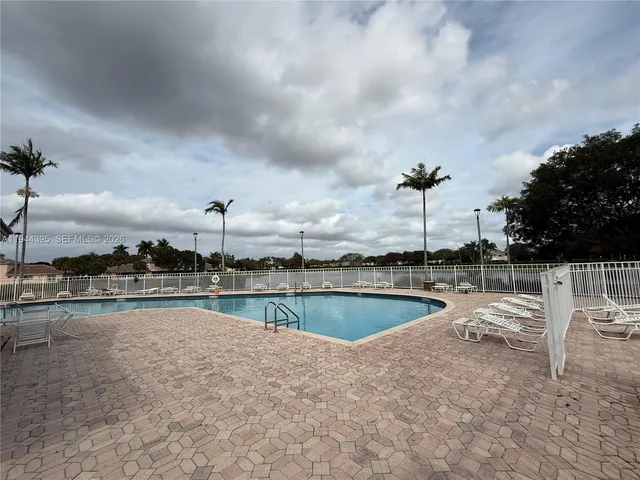 a view of a swimming pool with a table and chairs
