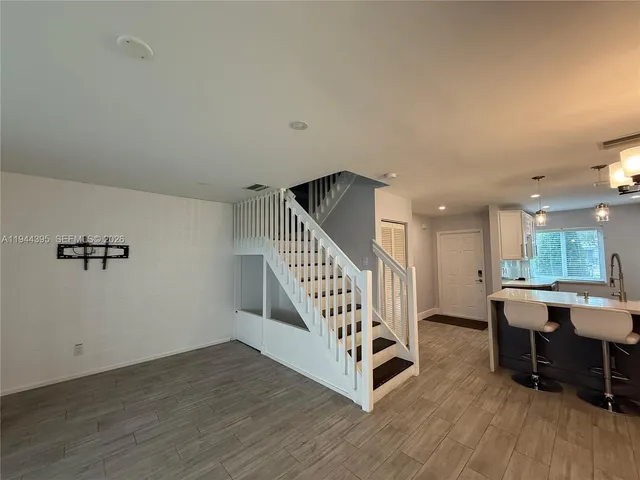 a view of a livingroom with furniture and hardwood floor