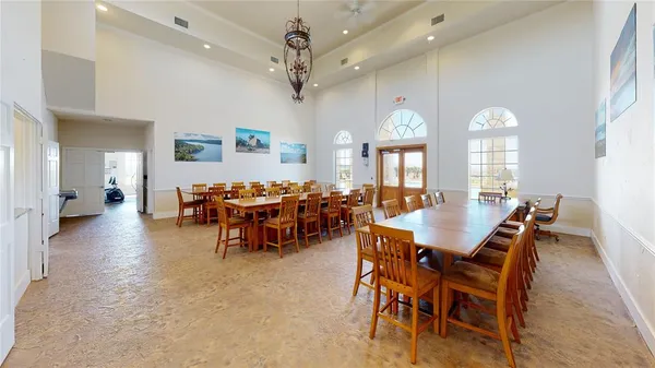 a view of a dining room with furniture and a chandelier