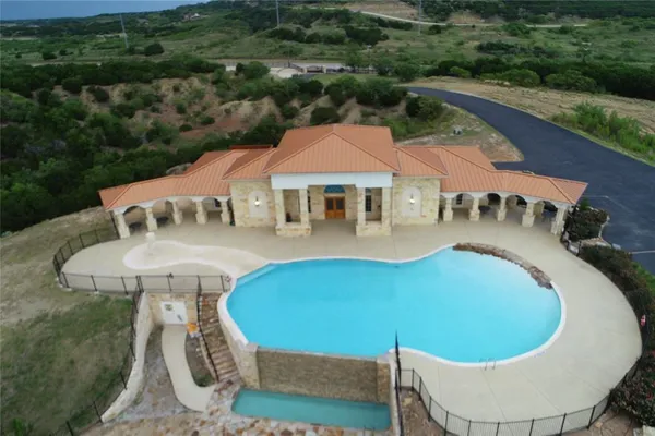 swimming pool view with a seating space