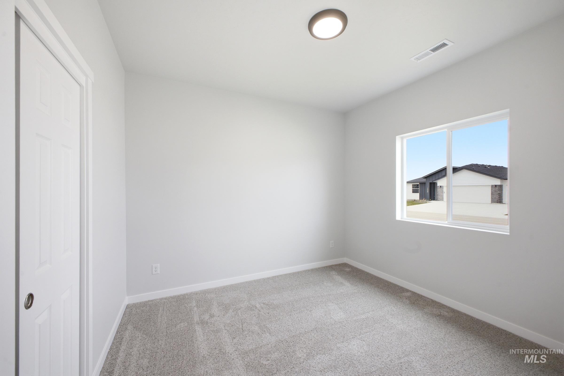 14104 Shiny Spruce Street Caldwell, ID 83607 - Photo 11 of 20 Room featuring light grey walls and grey carpet flooring