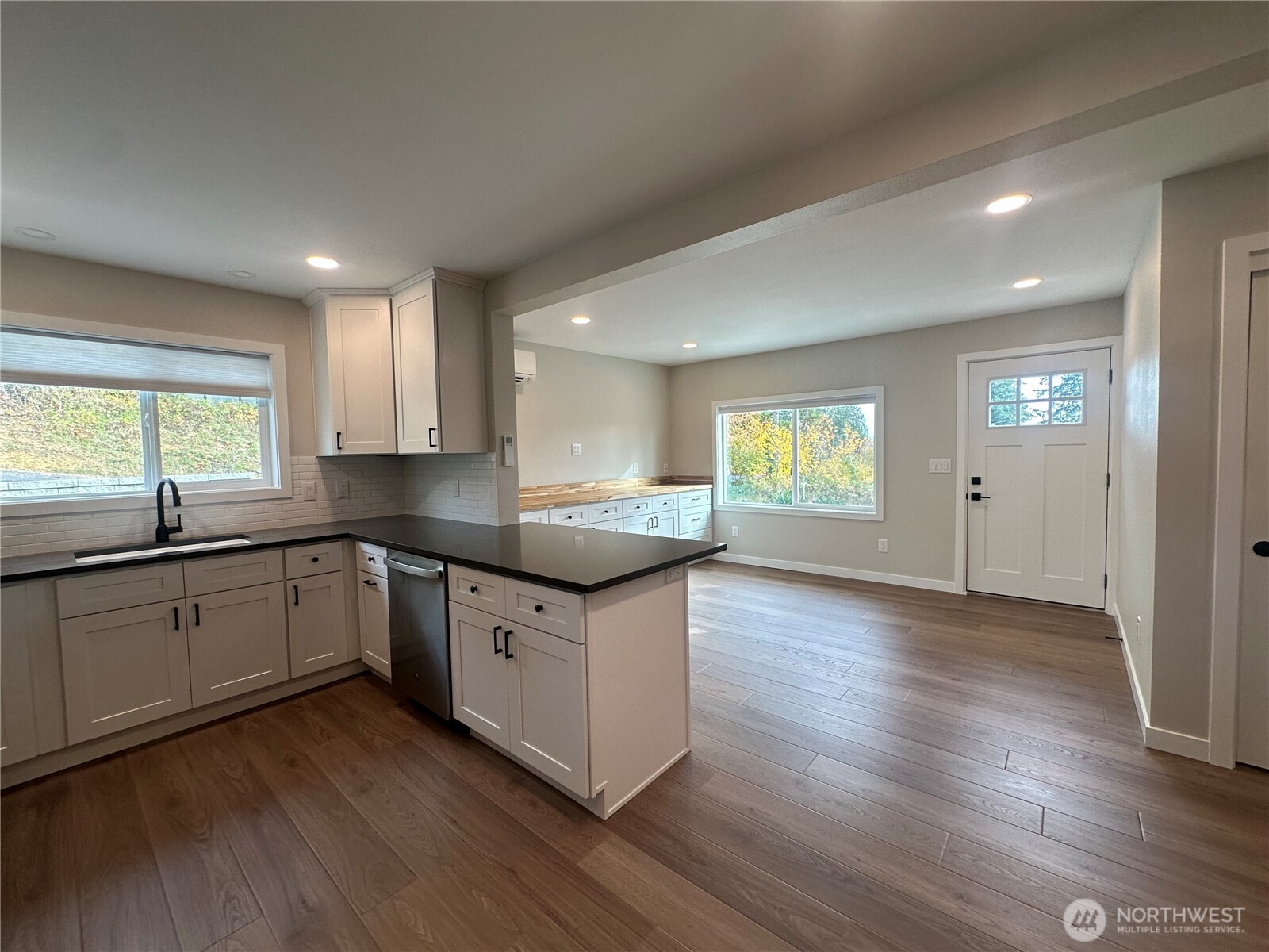 125 Foxglove Terrace Longview, WA 98632 - Photo 3 of 20 a kitchen with granite countertop wooden floors and white cabinets