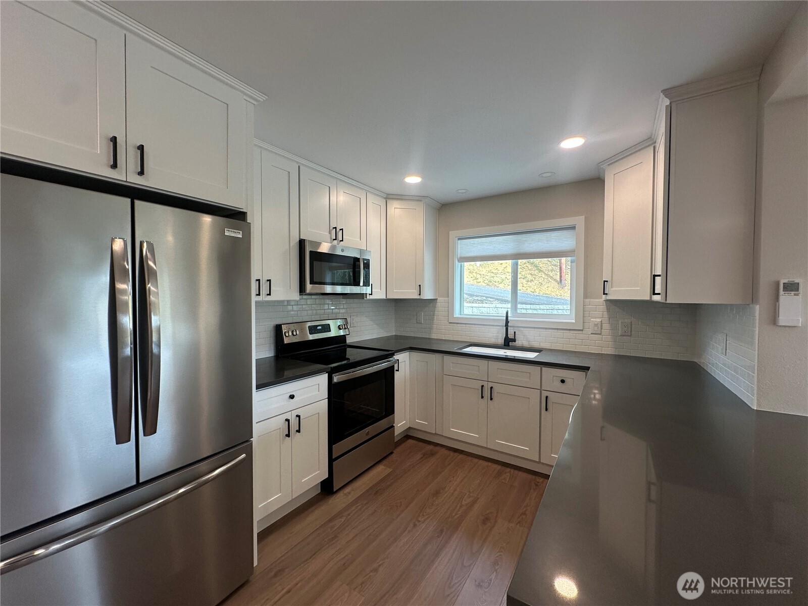 125 Foxglove Terrace Longview, WA 98632 - Photo 4 of 20 a kitchen with granite countertop stainless steel appliances a refrigerator sink and microwave