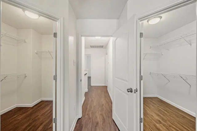 a view of a hallway with wooden floor