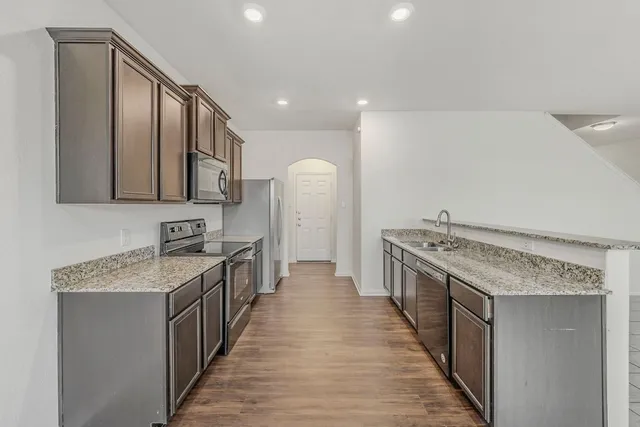 a kitchen with a stove and a sink