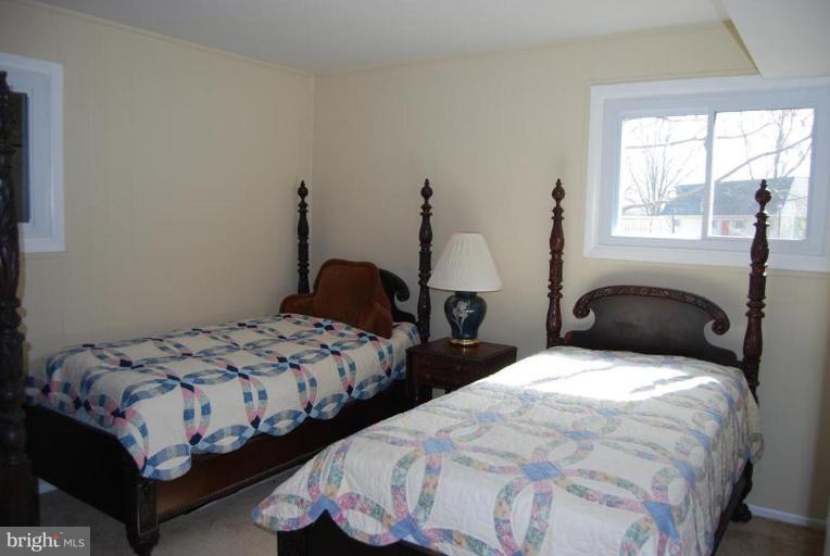 17317 Fletchall Road Poolesville, MD 20837 - Photo 13 of 18 a bedroom with two beds and a window