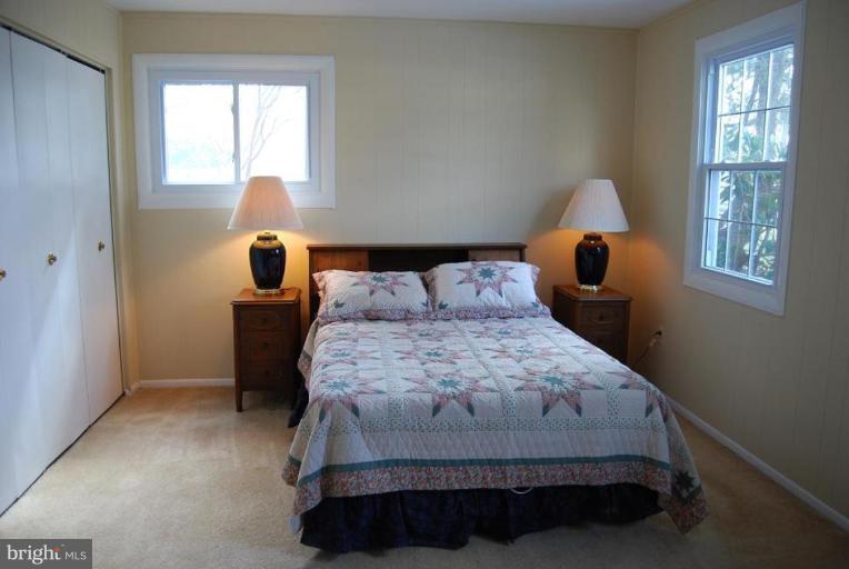 17317 Fletchall Road Poolesville, MD 20837 - Photo 14 of 18 a bedroom with a bed and window