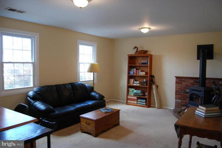 17317 Fletchall Road Poolesville, MD 20837 - Photo 16 of 18 a living room with furniture and a flat screen tv