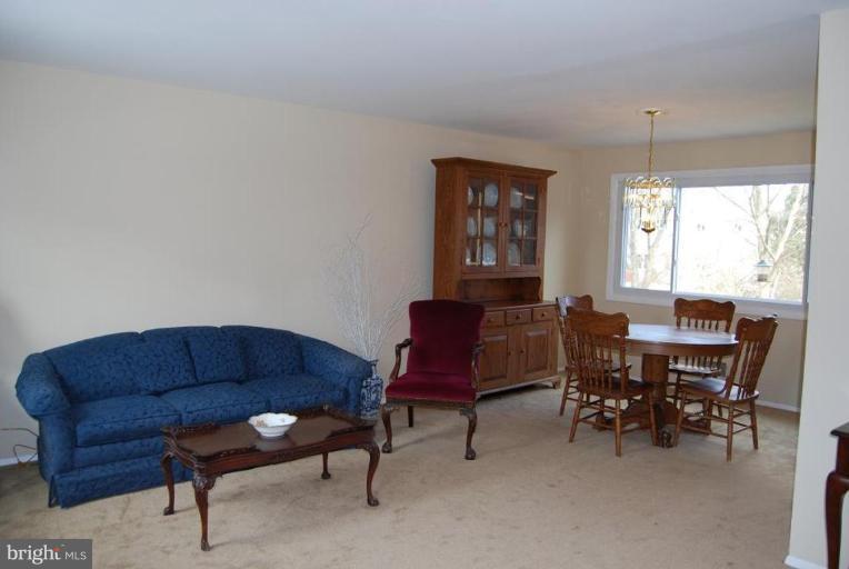 17317 Fletchall Road Poolesville, MD 20837 - Photo 6 of 18 a living room with furniture and a chandelier