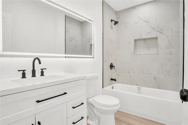 a bathroom with a sink toilet a bathtub and shower