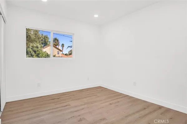 a view of a small space with wooden floor and a window
