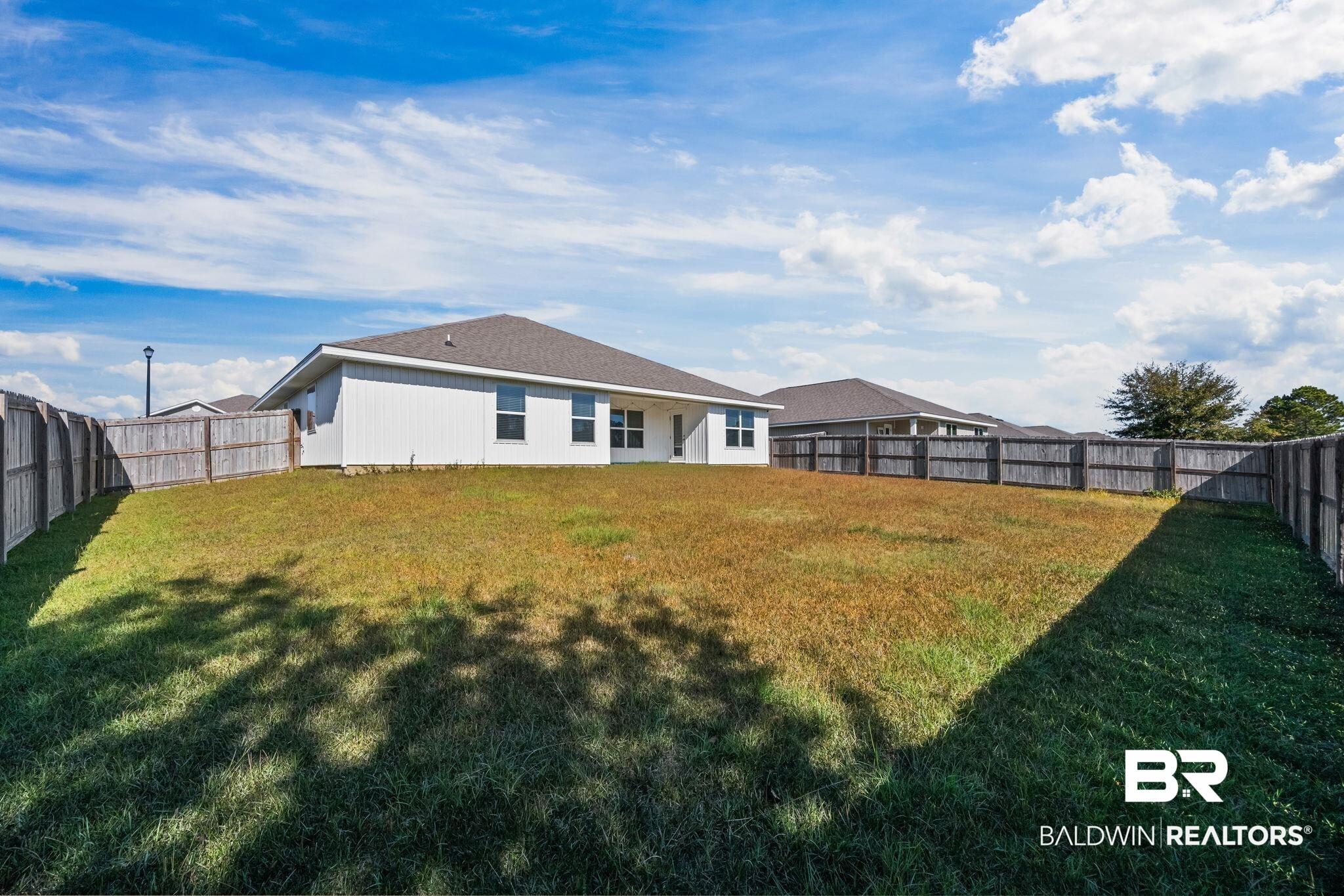 3090 Camino Real Loop Lillian, AL 36549 - Photo 5 of 29 Rear view of property featuring a fenced backyard and a patio area