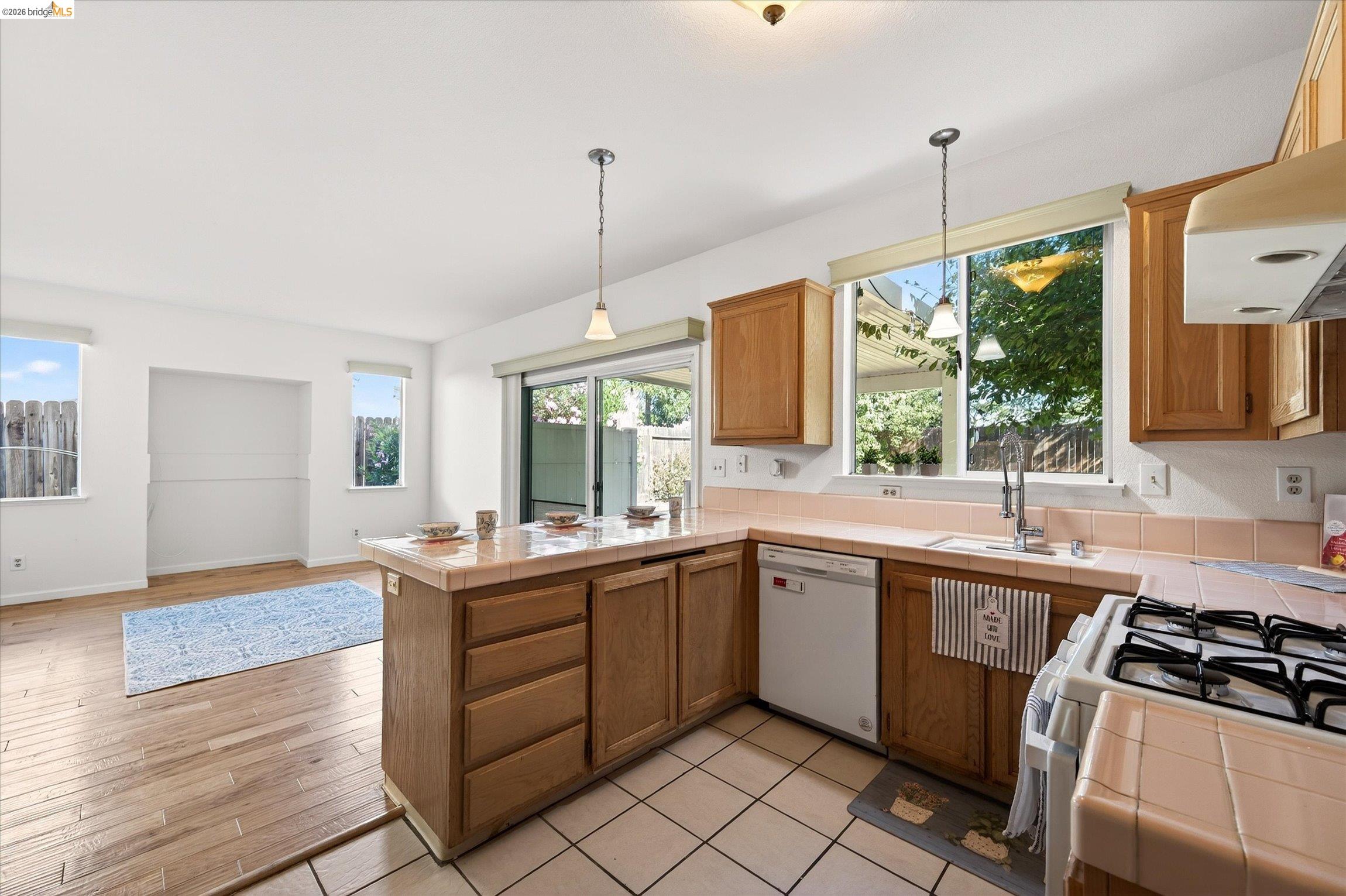 1120 Deerpark Road Oakley, CA 94561 - Photo 16 of 30 Kitchen featuring wood-finish cabinetry, tile countertops, and a built-in gas range