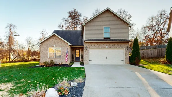 a front view of a house with a yard and garage