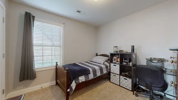 a bedroom with a bed and a chair