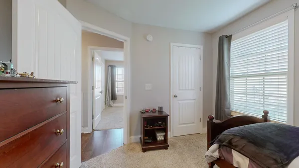 a living room with a bed furniture and a window