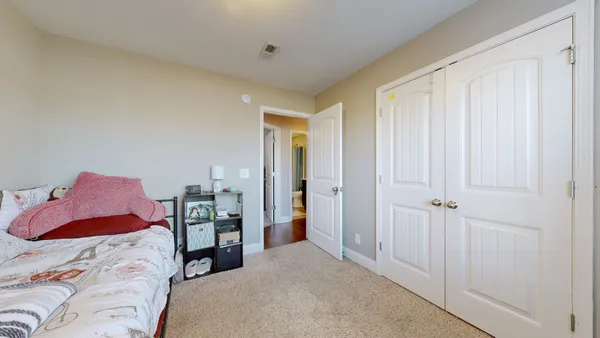 a bedroom with a bed and a closet