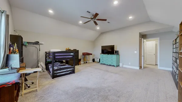 a view of a livingroom with furniture and a flat screen tv