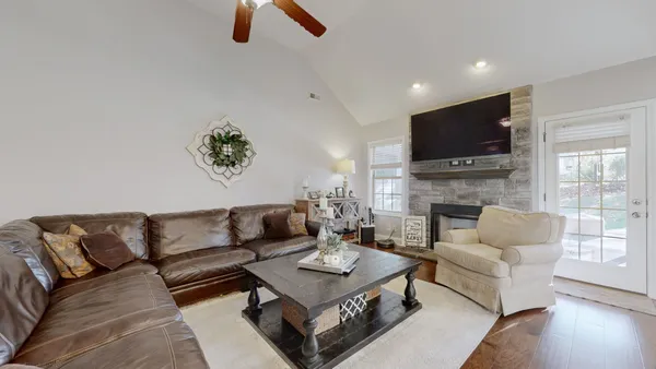 a living room with furniture a fireplace and a flat screen tv