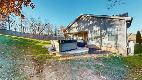 a view of a house with backyard and sitting area