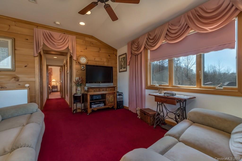 2141 Coxe Road, Unit 96 Rutherfordton, NC 28139 - Photo 14 of 25 a living room with furniture a flat screen tv and a large window