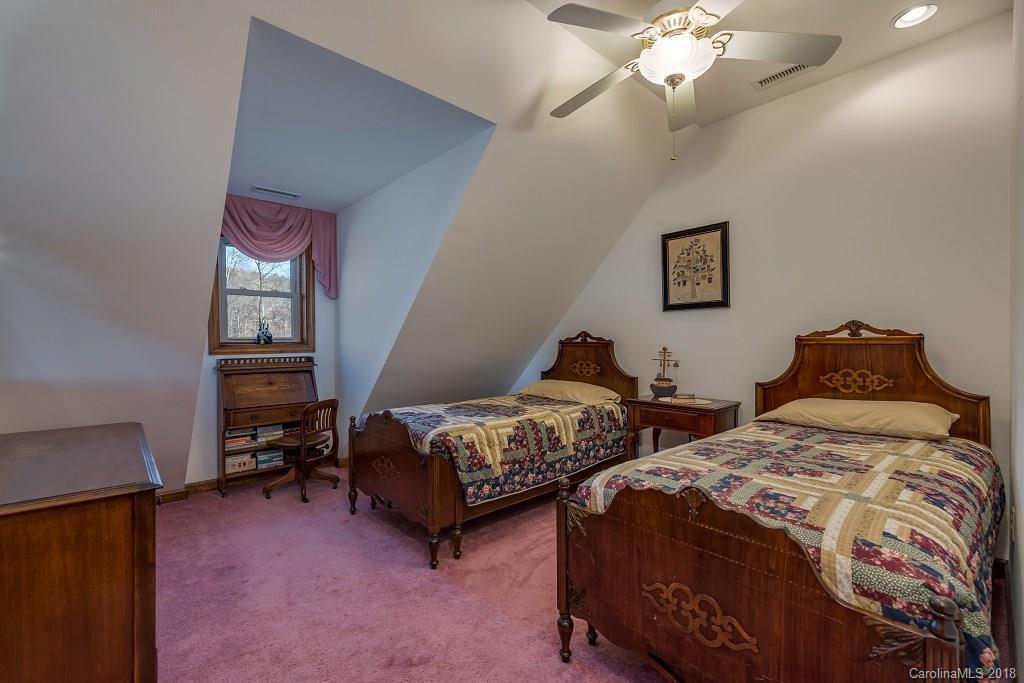 2141 Coxe Road, Unit 96 Rutherfordton, NC 28139 - Photo 15 of 25 a bedroom with two beds and a chandelier