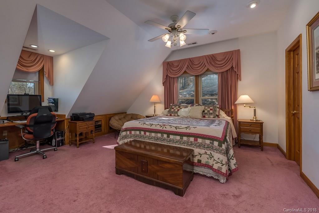 2141 Coxe Road, Unit 96 Rutherfordton, NC 28139 - Photo 17 of 25 a bedroom with a bed a chandelier and dresser