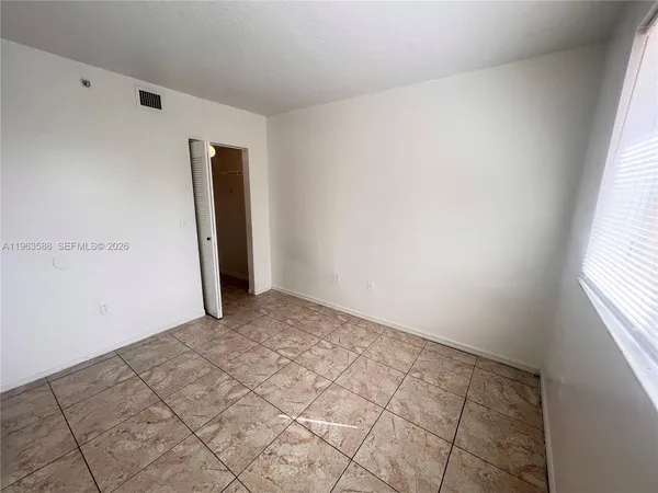 a view of an empty room and window