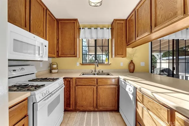 a kitchen with stainless steel appliances a sink stove and cabinets