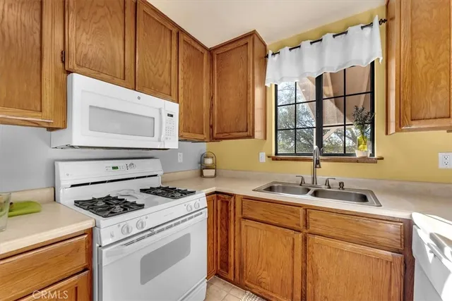 a kitchen with a sink stove and cabinets