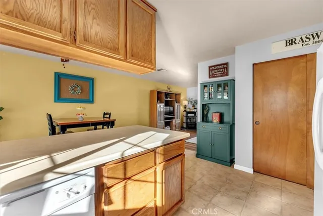a spacious bedroom with a bed and a chandelier