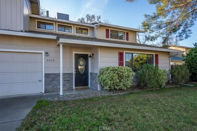 a front view of a house with a garden