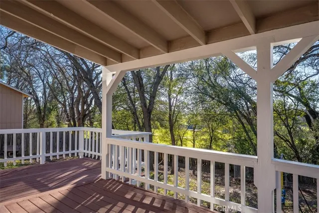 a view of house with deck and wooden floor