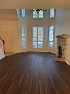 a view of a livingroom with wooden floor and a fireplace