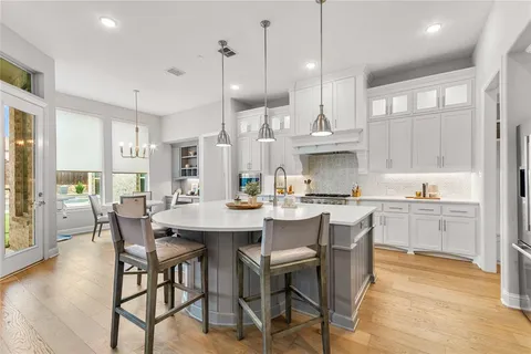 a large kitchen with a table and chairs
