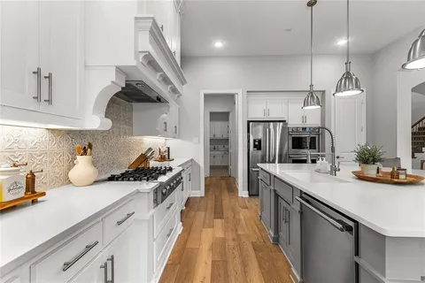 a kitchen with a sink a stove and cabinets