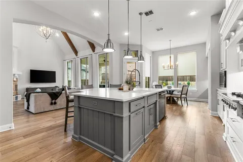 a kitchen with counter top space and wooden floor