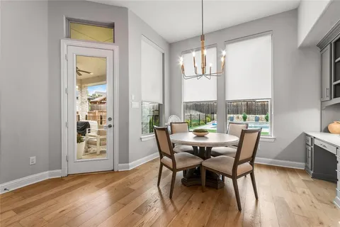 a view of a dining room with furniture and windows