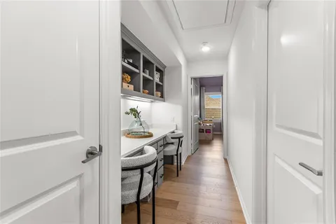 a bedroom with a bed and a flat tv screen on dresser